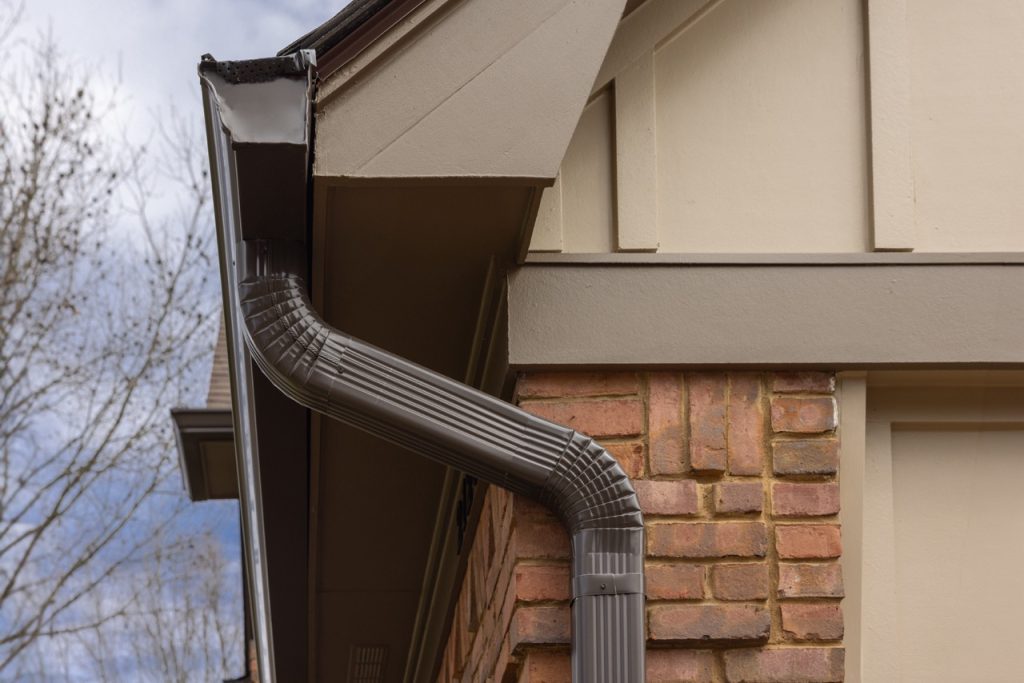 Memphis home with tan siding, black windows, door and gutters