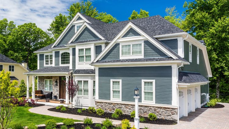 Newly installed primed Hardie siding on a home.
