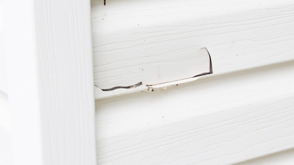 Cracked and damaged siding on a home