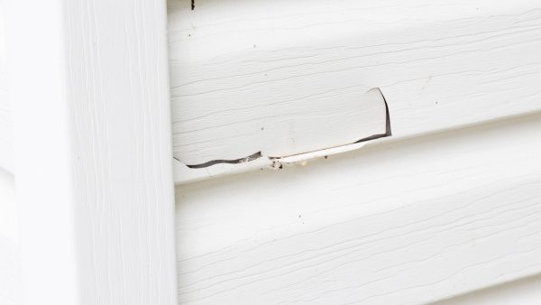 Cracked and damaged siding on a home