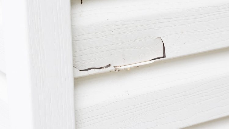 Cracked and damaged siding on a home